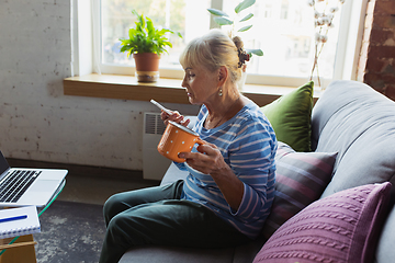 Image showing Senior woman studying at home, getting online courses