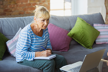 Image showing Senior woman studying at home, getting online courses