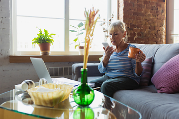 Image showing Senior woman studying at home, getting online courses