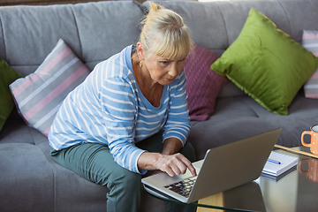 Image showing Senior woman studying at home, getting online courses