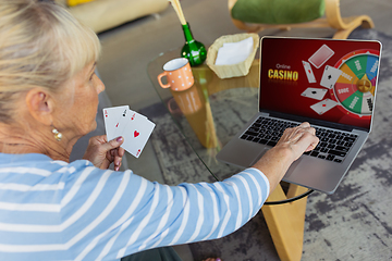 Image showing Senior woman studying at home, getting online courses