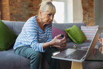 Image showing Senior woman studying at home, getting online courses