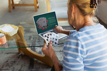 Image showing Senior woman studying at home, getting online courses