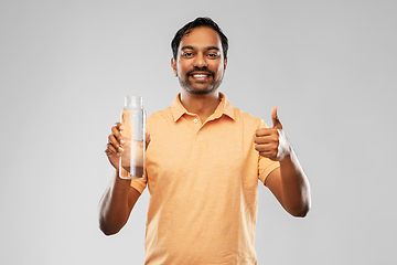 Image showing man with water in glass bottle showing thumbs up