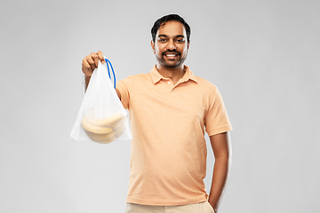 Image showing happy man holding reusable string bag with bananas