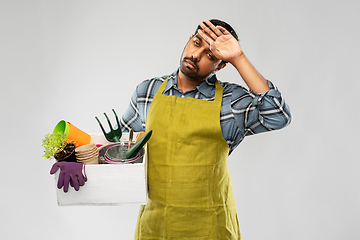 Image showing tired gardener or farmer with box of garden tools