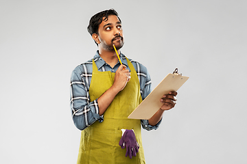 Image showing indian gardener or farmer with clipboard thinking