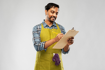 Image showing happy indian gardener or farmer with clipboard