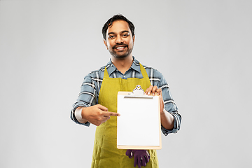 Image showing happy indian gardener or farmer showing clipboard
