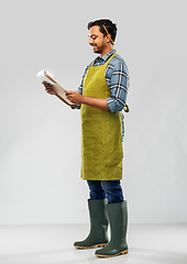 Image showing happy indian gardener or farmer with clipboard