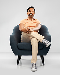 Image showing happy smiling young indian man sitting in chair