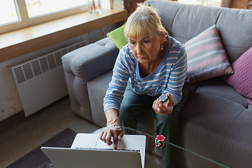 Image showing Senior woman studying at home, getting online courses