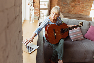 Image showing Senior woman studying at home, getting online courses