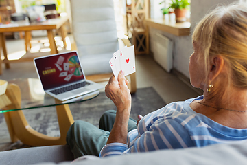 Image showing Senior woman studying at home, getting online courses