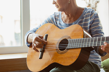 Image showing Senior woman studying at home, getting online courses