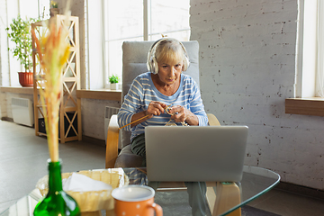 Image showing Senior woman studying at home, getting online courses