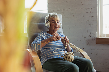 Image showing Senior woman studying at home, getting online courses