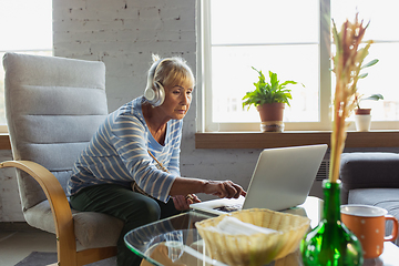 Image showing Senior woman studying at home, getting online courses