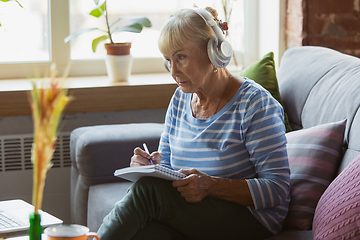 Image showing Senior woman studying at home, getting online courses