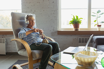 Image showing Senior woman studying at home, getting online courses