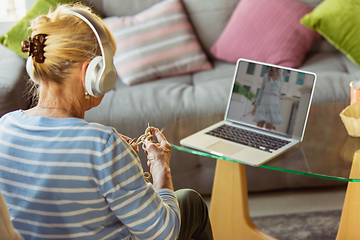 Image showing Senior woman studying at home, getting online courses