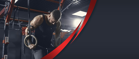 Image showing The male athlete training hard in the gym. Fitness and healthy lifestyle concept. Flyer.