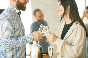 Image showing People clinking glasses with wine or champagne. Happy cheerful friends celebrate holidays, meeting. Close up shot of smiling friends, lifestyle