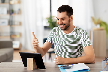 Image showing man with tablet pc having video call at home