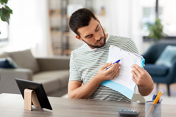 Image showing man with tablet pc having video call at home