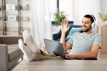 Image showing man with laptop and headphones having video call