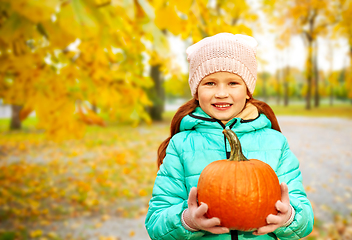 Image showing happy redhead girl with pumpkin at autumn park