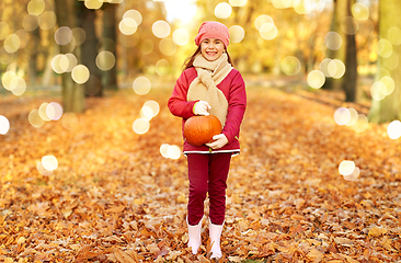 Image showing happy girl with pumpkin at autumn park