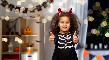 Image showing girl in black dress and devil's horns on halloween