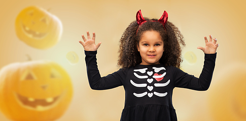 Image showing girl in black dress and devil's horns on halloween