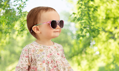 Image showing happy little baby girl in sunglasses over nature