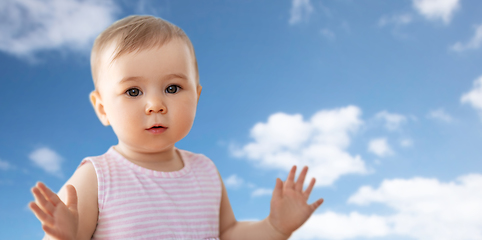 Image showing portrait of little baby girl over blue sky