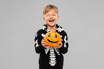 Image showing happy boy in halloween costume with jack-o-lantern