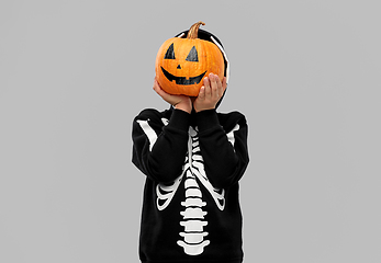 Image showing boy in halloween costume with jack-o-lantern