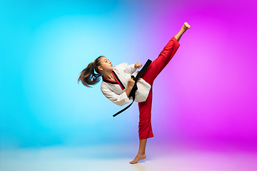 Image showing Karate, taekwondo girl with black belt isolated on gradient background in neon light