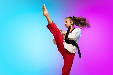 Image showing Karate, taekwondo girl with black belt isolated on gradient background in neon light