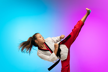 Image showing Karate, taekwondo girl with black belt isolated on gradient background in neon light