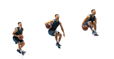 Image showing Young basketball player against white studio background in motion of step-to-step goal