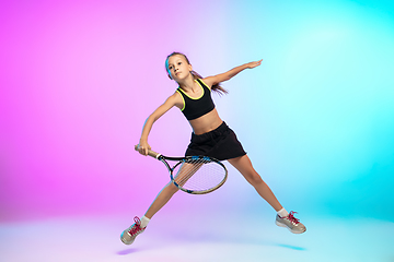 Image showing Little tennis girl in black sportwear isolated on gradient background in neon light