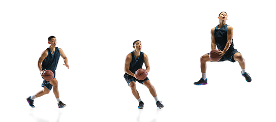 Image showing Young basketball player against white studio background in motion of step-to-step goal