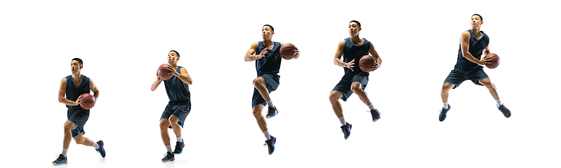 Image showing Young basketball player against white studio background in motion of step-to-step goal