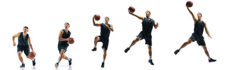 Image showing Young basketball player against white studio background in motion of step-to-step goal