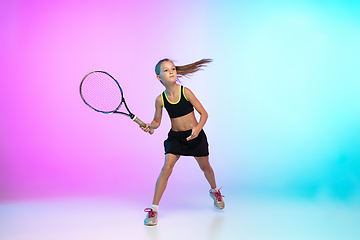 Image showing Little tennis girl in black sportwear isolated on gradient background in neon light