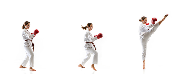 Image showing Confident junior in kimono practicing taekwondo combat, martial arts