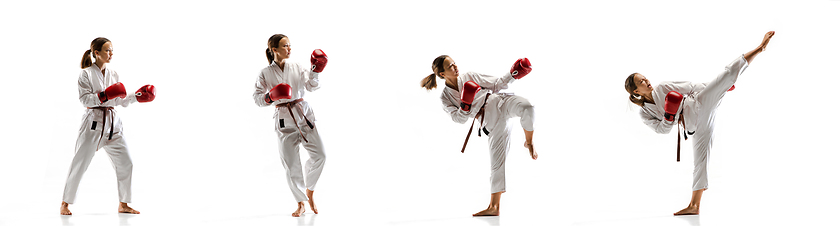 Image showing Confident junior in kimono practicing taekwondo combat, martial arts