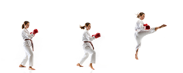 Image showing Confident junior in kimono practicing taekwondo combat, martial arts